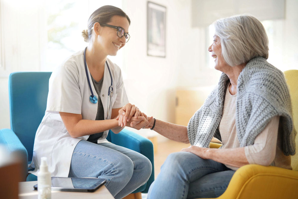 Young doctor encouraging older woman to undergo CBT for addiction