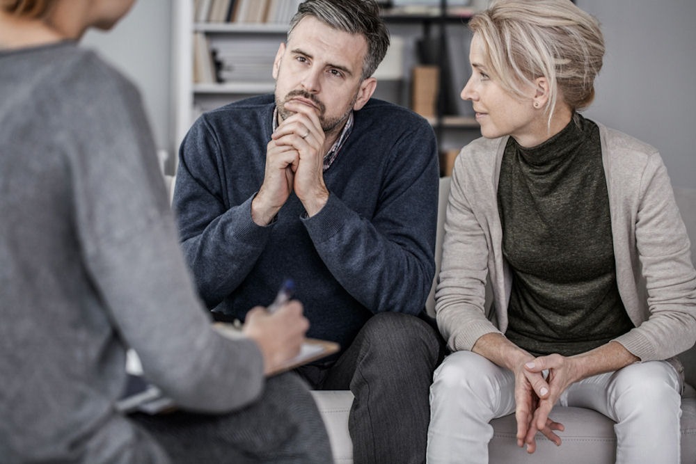 Middle-aged couple speaking to therapist about depression.