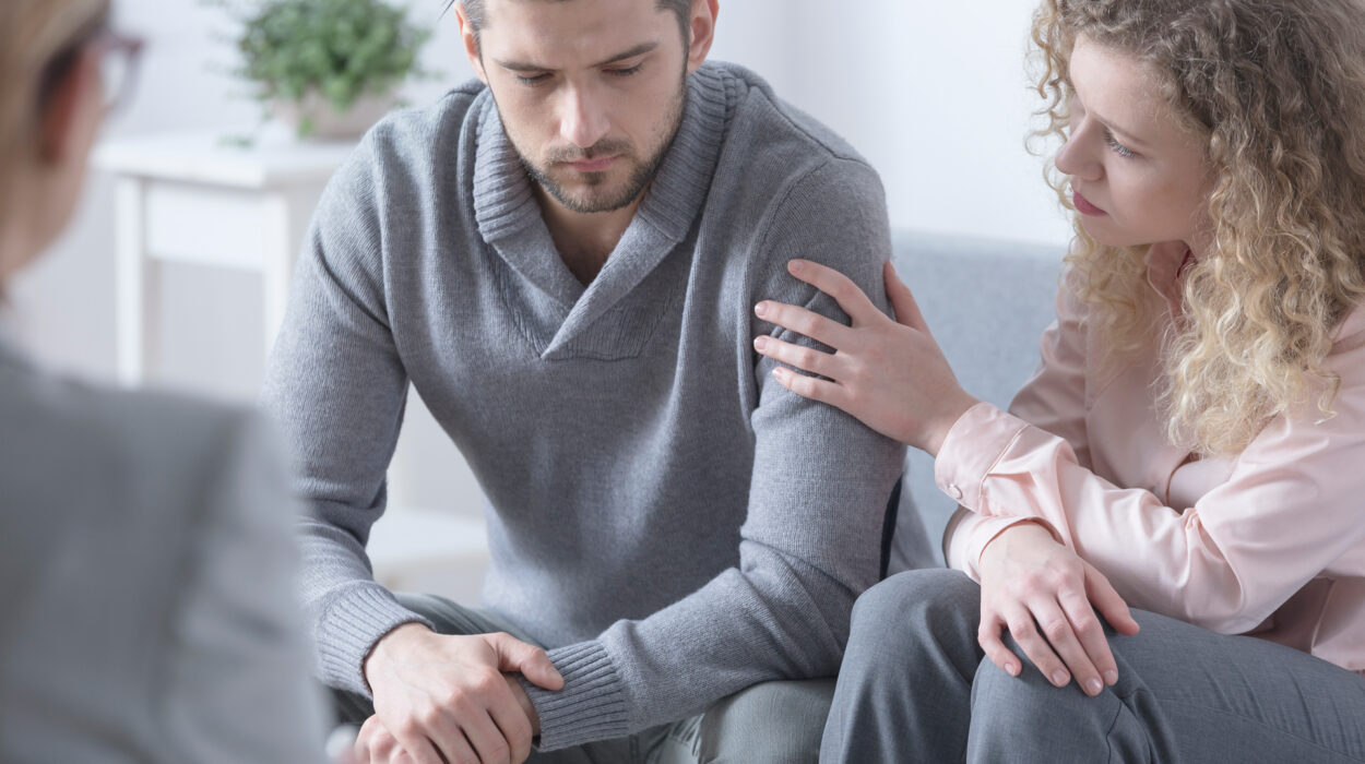 Woman reassuring man during couples therapy about codependency.