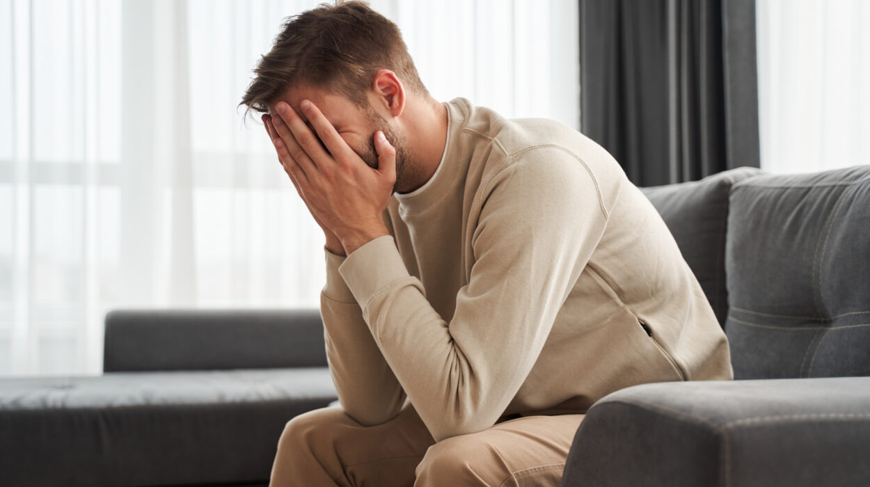 Man leans over and covers face when discussing relapse.