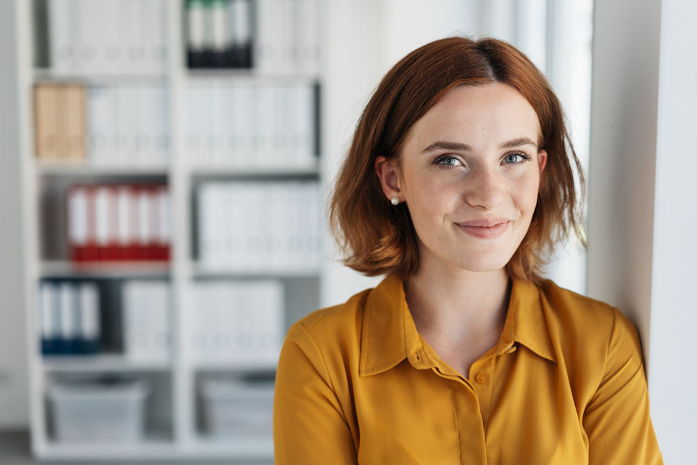 Woman looking out from mental health treatment library after completing treatment for OCD.