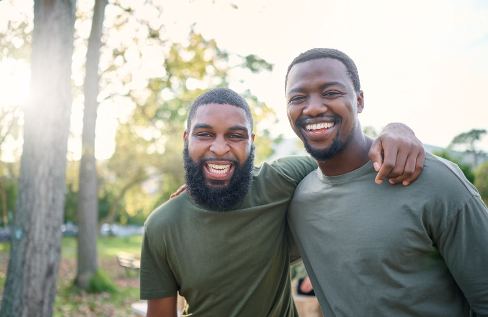 Two men giving each other a side hug.